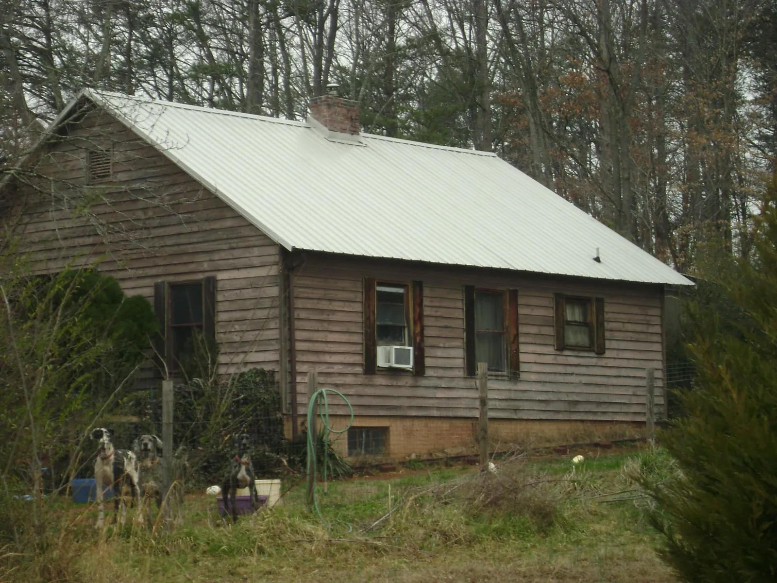 White metal roof on an old wood sided farmhouse, from a Metal Roof Installation job in New Ross